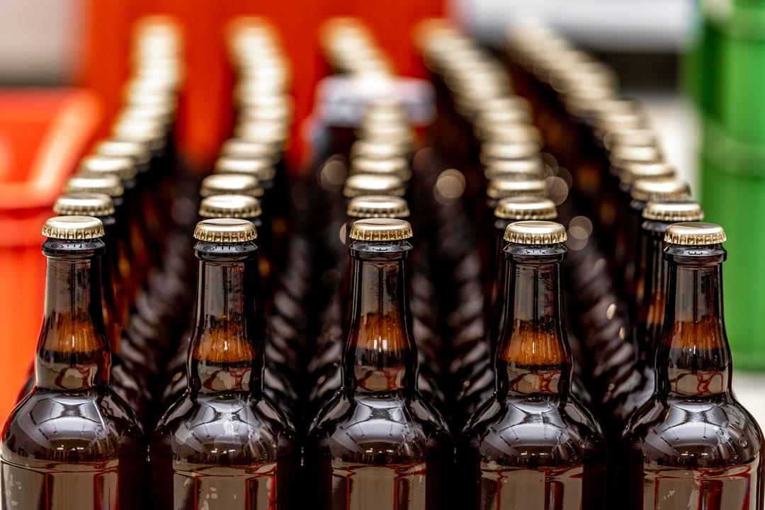 dewy-bottles-of-beer-in-a-row-in-a-warehouse-ready-2023-03-15-01-48-04-utc.jpg
